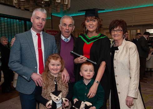 Graduation photo of female student and her family