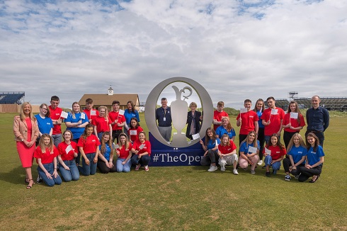 Group of Travel Tourism students pictured at the British Golf Open sign at Royal Portrush Golf Club
