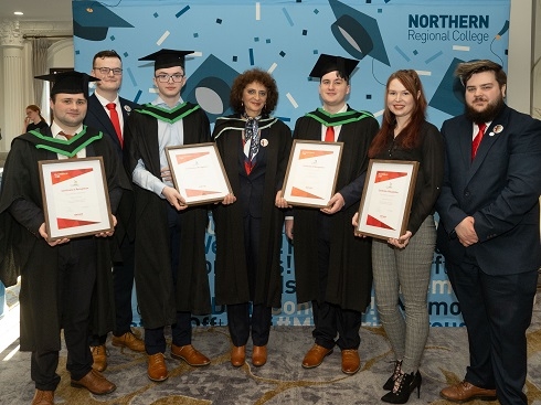 Group holding certificates at graduation ceremony