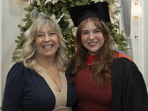 Two females at graduation ceremony