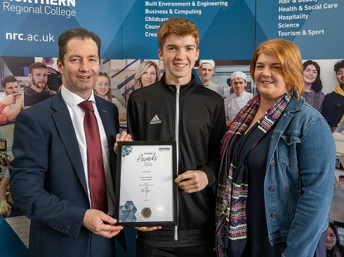 Male student being presented with certificate
