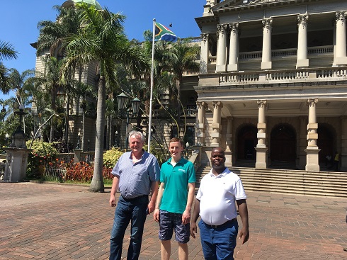 Male staff and student pictured outside a building in South Africa